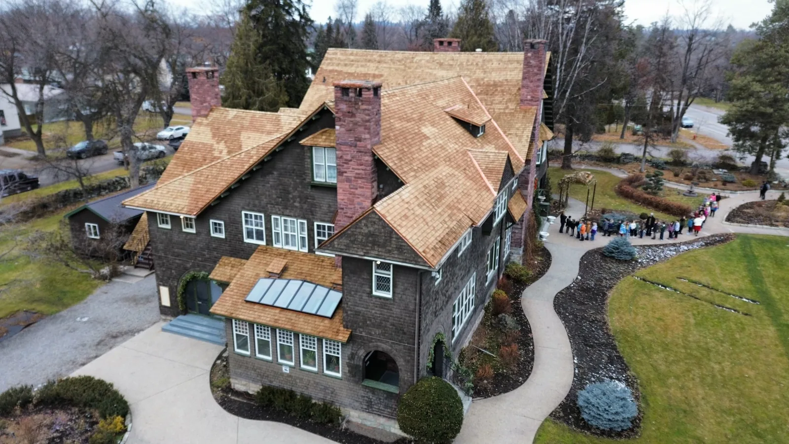 Aerial view of a cedar shingle roof on a large shingle-style home